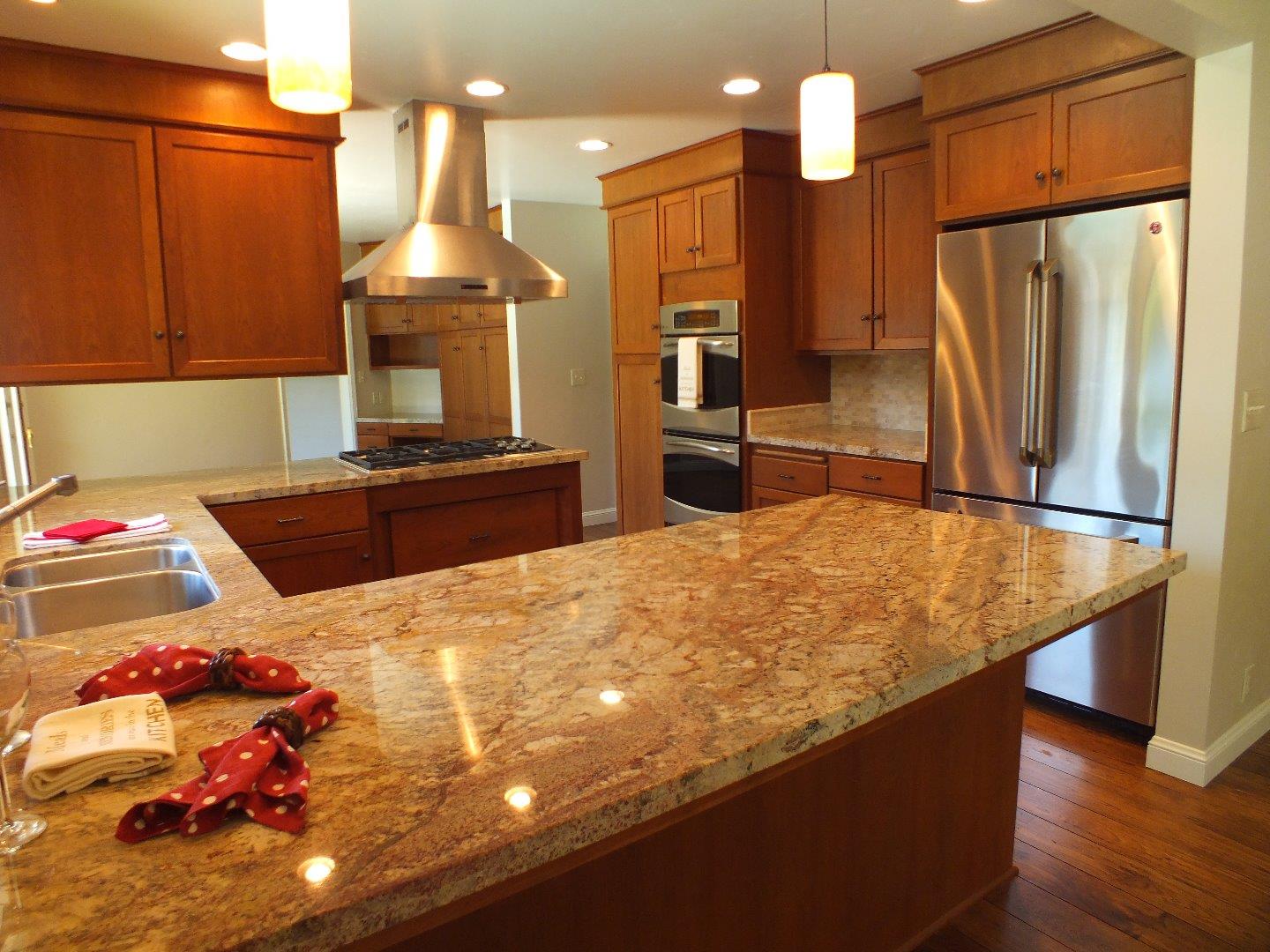 202 Rio Verde Drive Salinas, CA 93901 - Photo 8 of 35 a kitchen with stainless steel appliances kitchen island granite countertop a refrigerator a stove and a sink with wooden floor