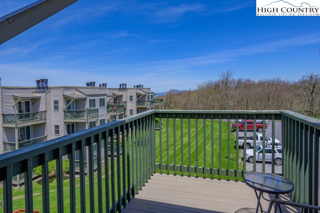 301 Pinnacle Inn Road, Unit 1302 Beech Mountain, NC 28604 - Photo 11 of 33 a view of a balcony with lake view and a floor to ceiling window