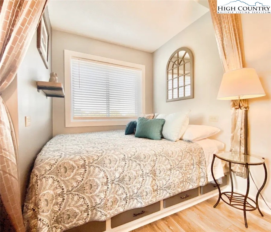 301 Pinnacle Inn Road, Unit 1302 Beech Mountain, NC 28604 - Photo 2 of 33 a bedroom with a bed and a window