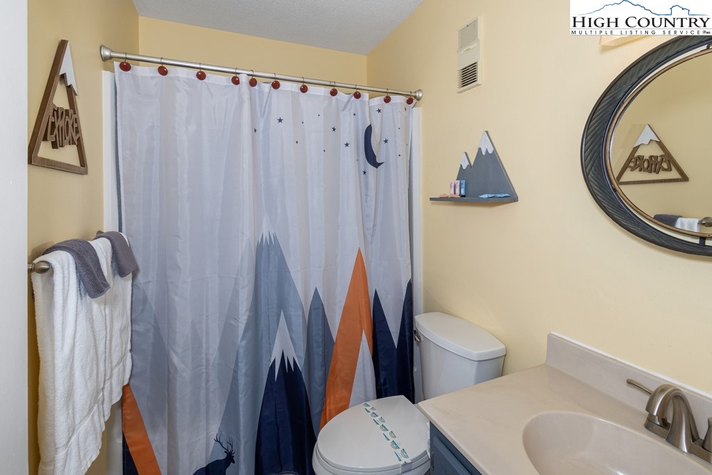 301 Pinnacle Inn Road, Unit 1302 Beech Mountain, NC 28604 - Photo 22 of 33 a white toilet sitting next to a bathroom sink