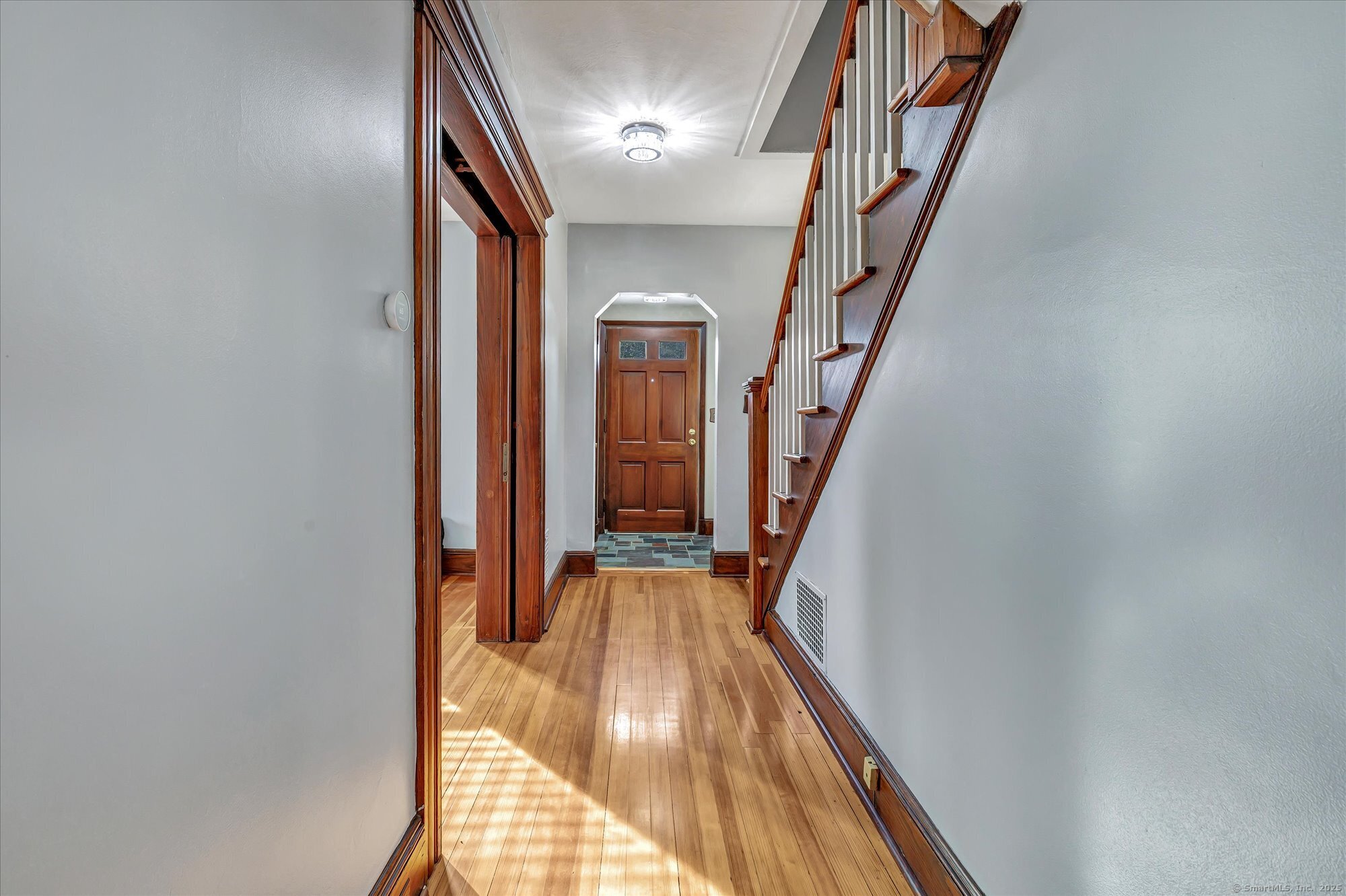 1250 Huntington Road Stratford, CT 06614 - Photo 8 of 39 a view of a hallway with wooden floor and staircase
