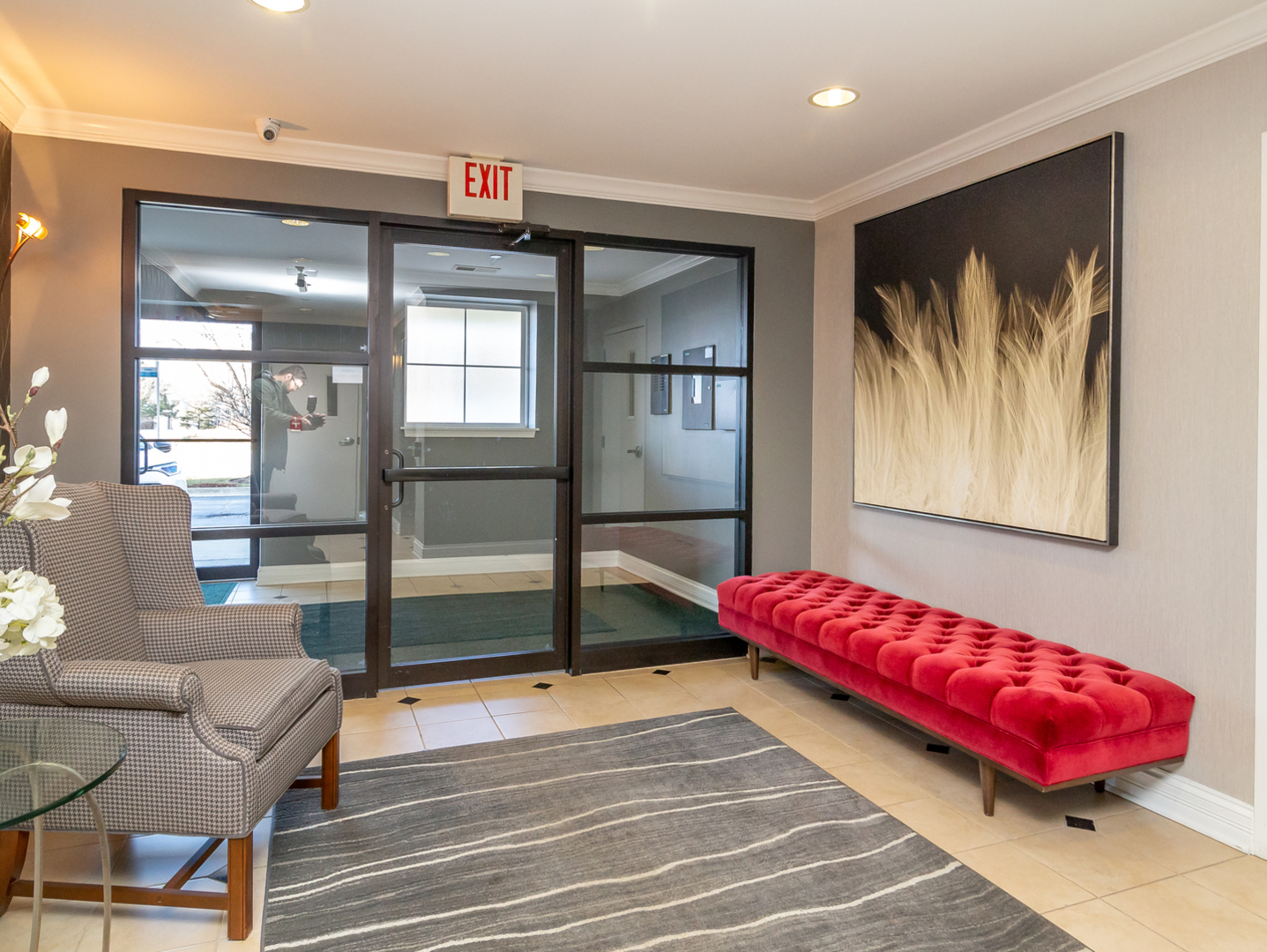 77 North Quentin Road, Unit 402 Palatine, IL 60067 - Photo 14 of 20 a living room with a couch and paintings on the wall