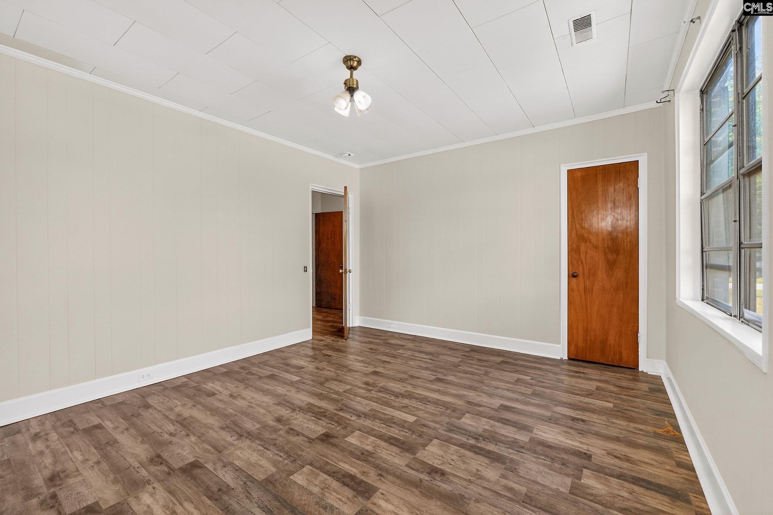 729 Magnolia Street Pelion, SC 29123 - Photo 13 of 32 a view of an empty room with wooden floor