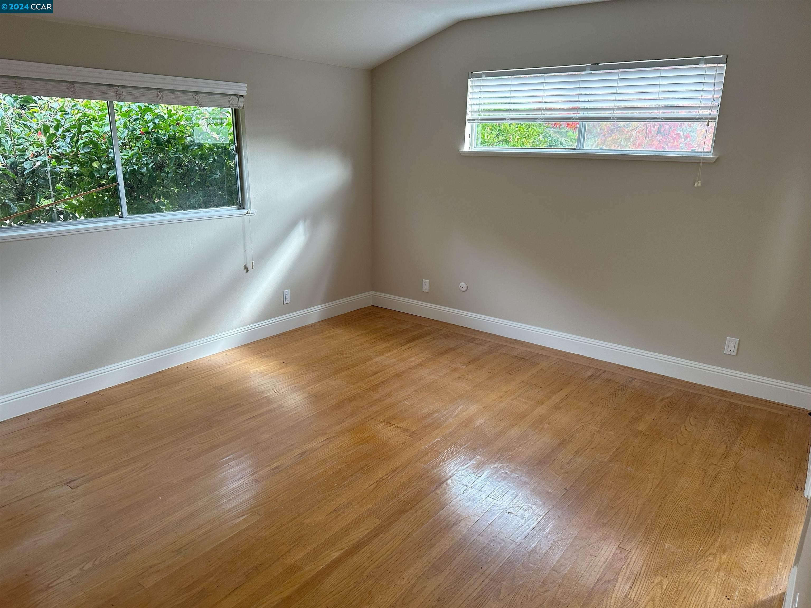 44 Lynwood Place Moraga, CA 94556 - Photo 11 of 14 an empty room with wooden floor and windows
