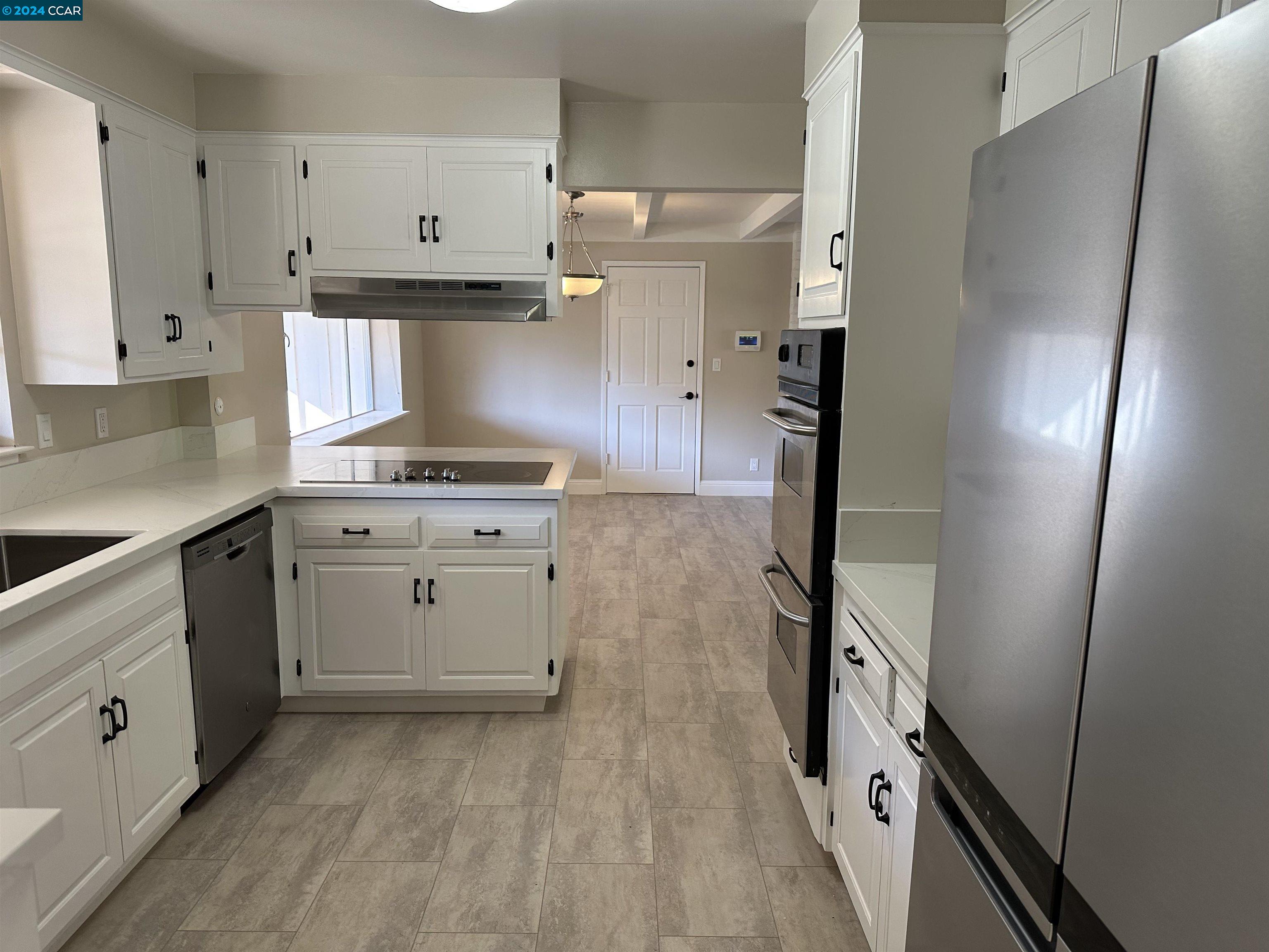 44 Lynwood Place Moraga, CA 94556 - Photo 2 of 14 a kitchen with white cabinets and white appliances