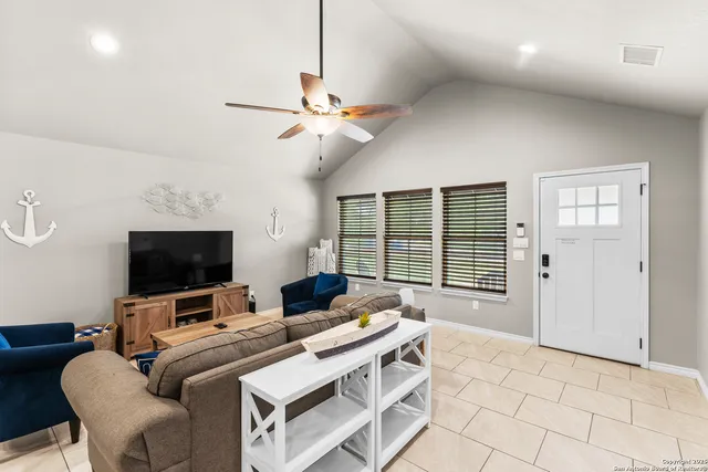 a view of a workspace with furniture and a flat screen tv