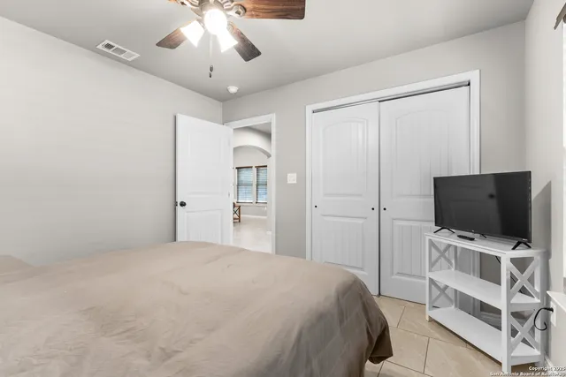 a bedroom with a bed and a flat screen tv