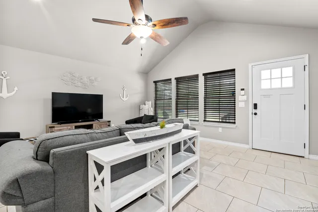 a view of a livingroom with furniture and a flat screen tv