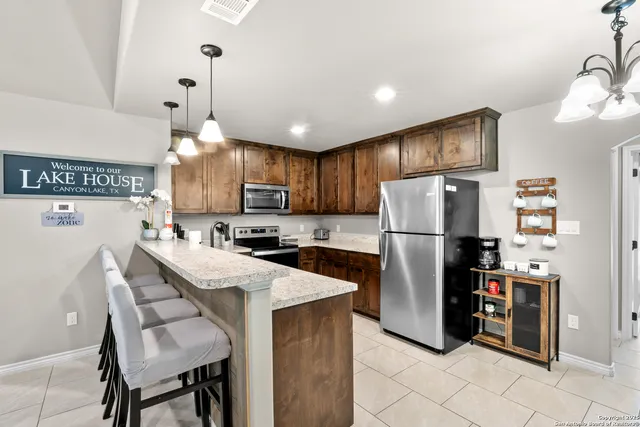 a kitchen with a sink stove and microwave