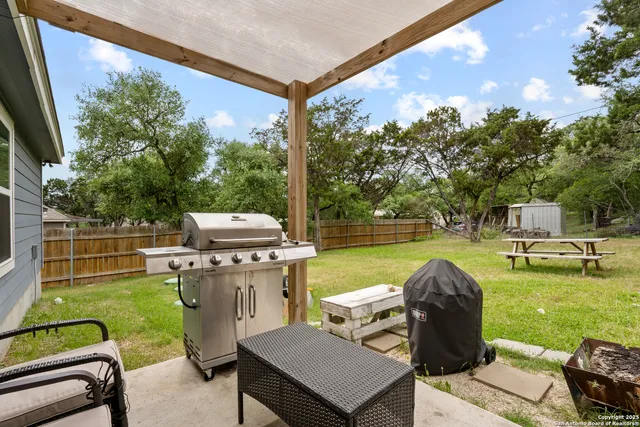 a backyard of a house with table and chairs