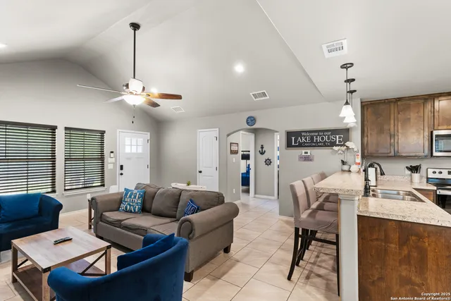 a living room with furniture and a chandelier