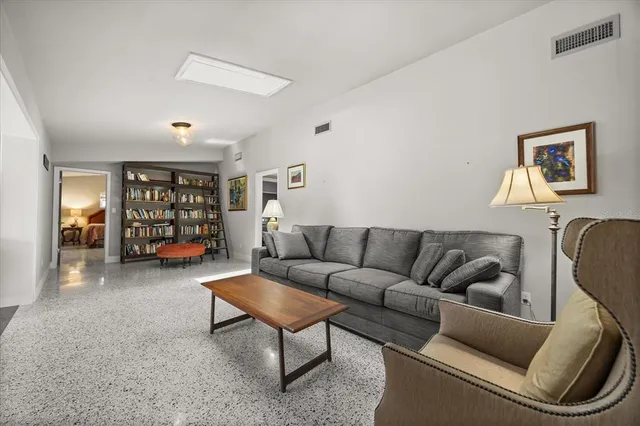 a living room with furniture and a bookshelf