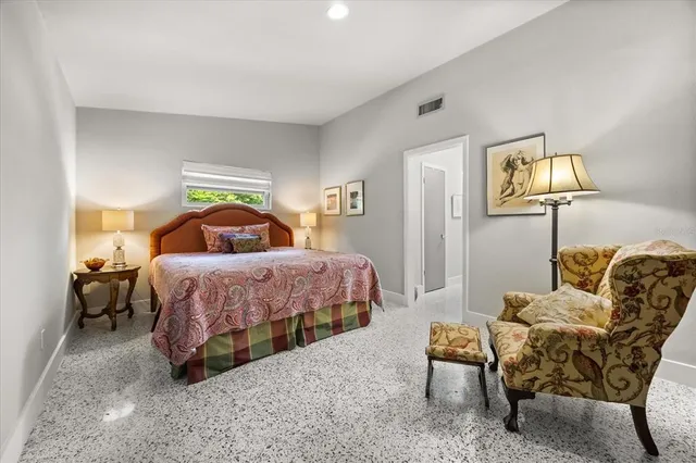 a bedroom with a bed and lamp