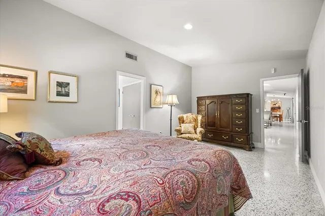 a bedroom with a bed and mirror