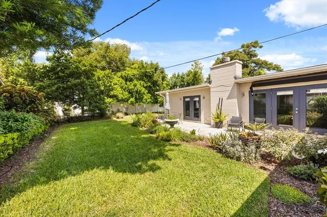 an aerial view of a residential houses with yard