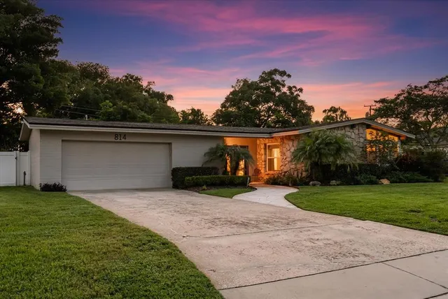 a view of a patio with table and chairs and potted plants