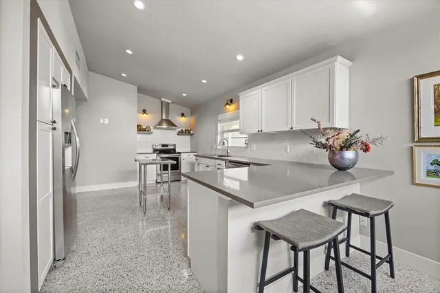 a kitchen with stainless steel appliances granite countertop a sink counter space and cabinets