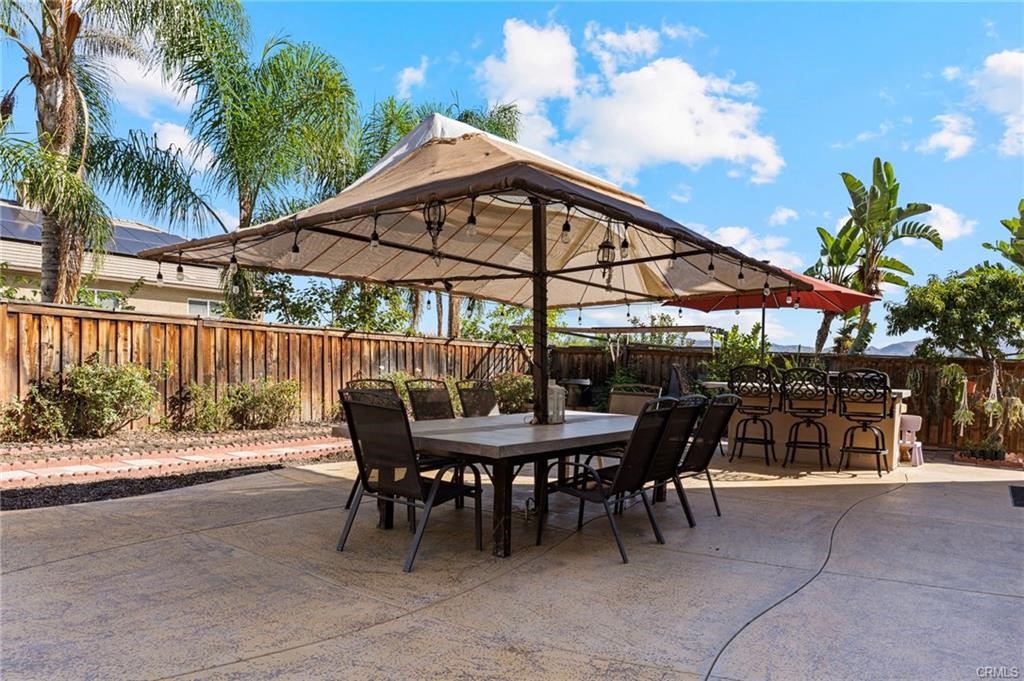 8634 Hunt Canyon Road Corona, CA 92883 - Photo 28 of 31 a view of a patio with a table and chairs