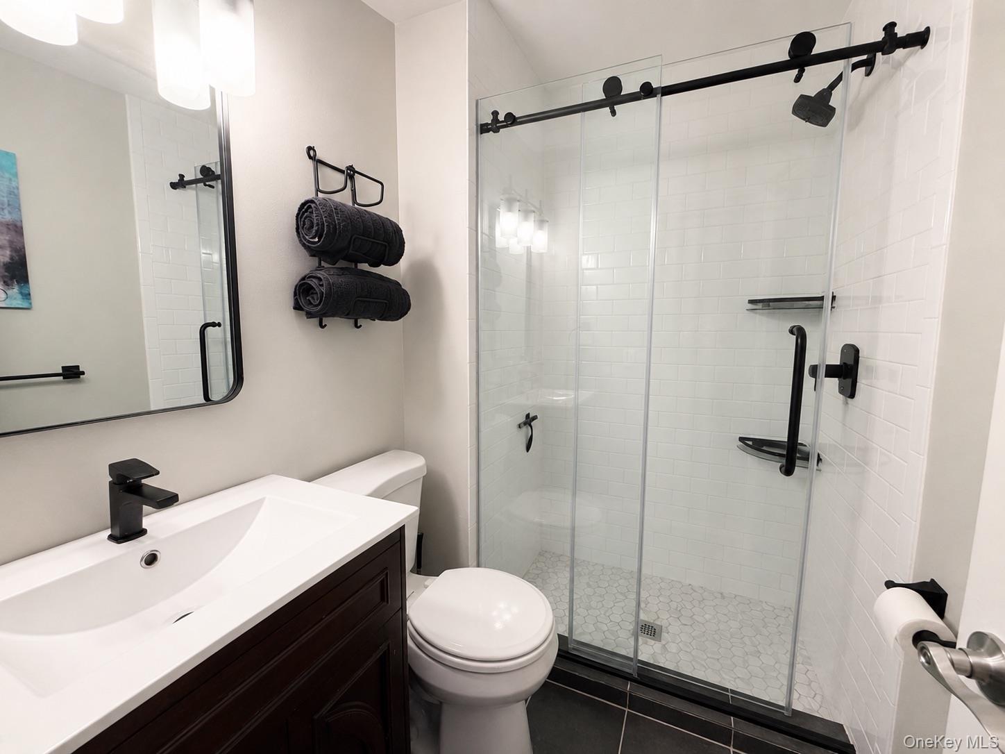 201 Birchwood Road, Unit 201 Coram, NY 11727 - Photo 15 of 27 a bathroom with a sink toilet and shower