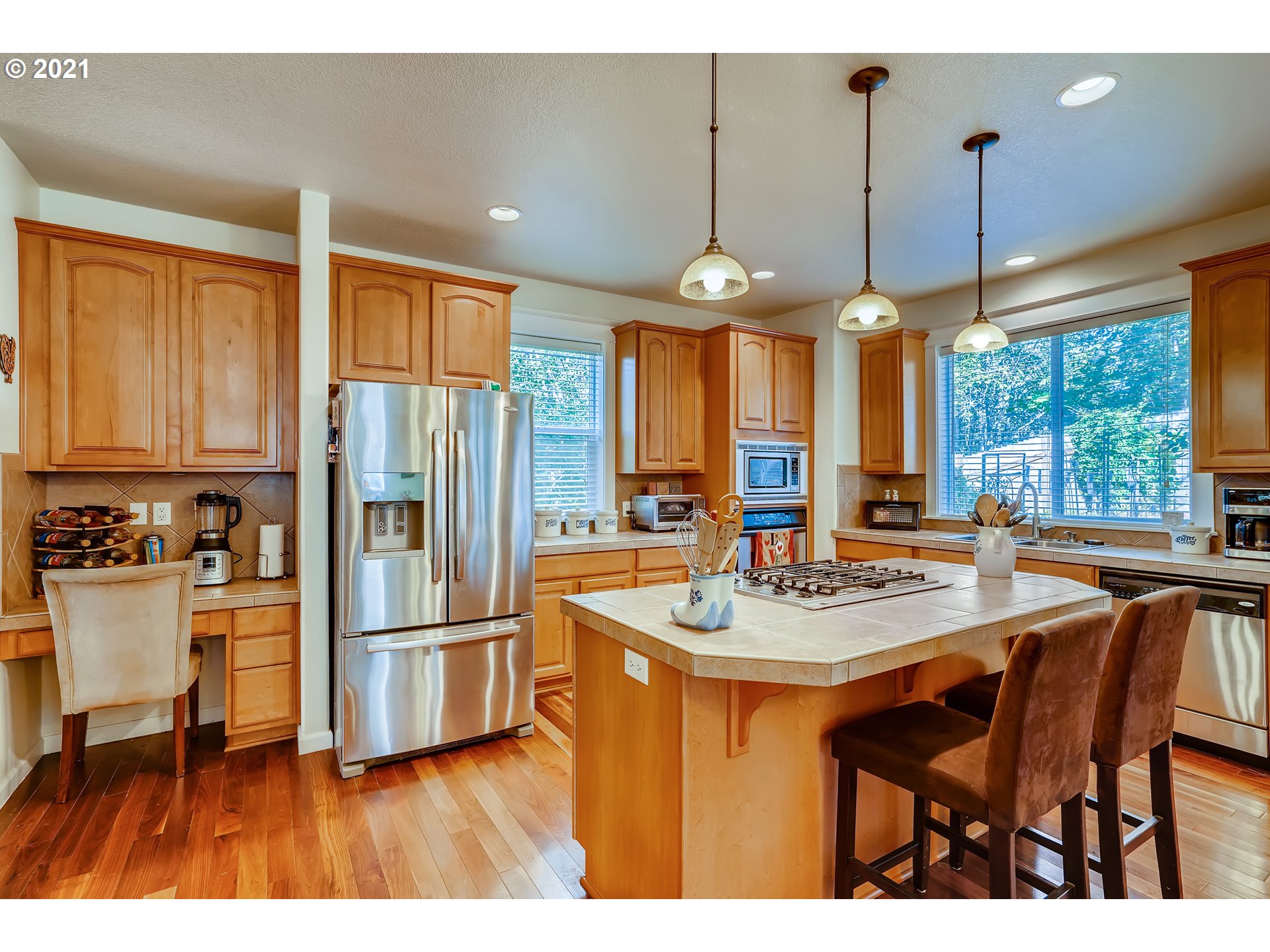35257 Juniper Drive St. Helens, OR 97051 - Photo 9 of 27 a kitchen with stainless steel appliances granite countertop a stove a refrigerator a sink a dining table and chairs with wooden floor