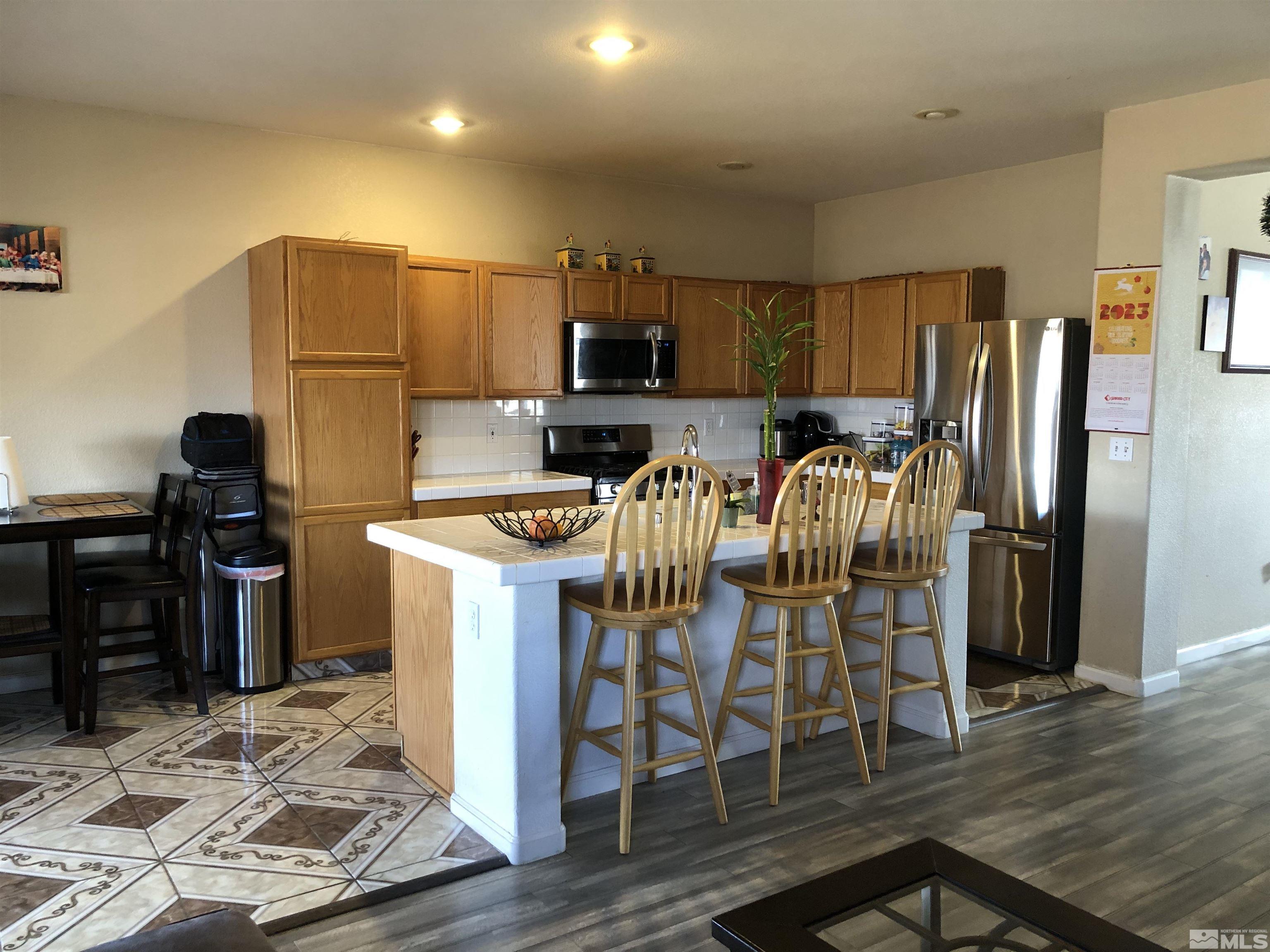 7925 Monterey Reno, NV 89506 - Photo 5 of 21 a kitchen with stainless steel appliances granite countertop a refrigerator stove microwave and sink