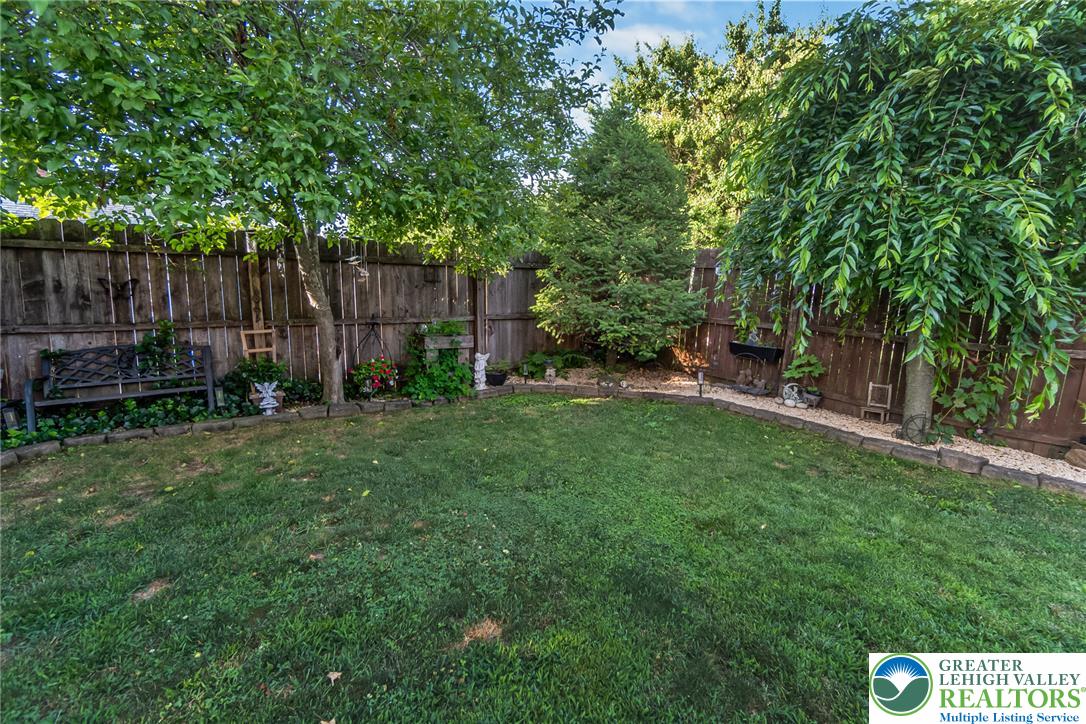 365 Rock Street Easton, PA 18042 - Photo 46 of 50 A private, verdant yard with mature trees and a charming garden border.