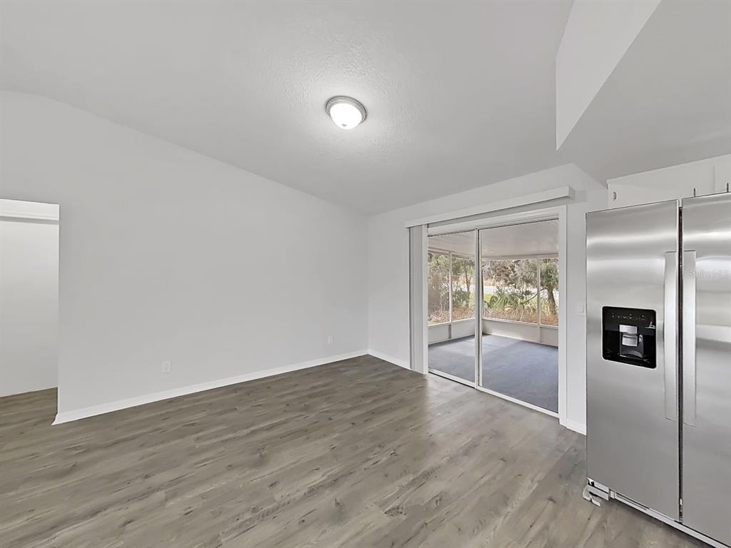 902 Great Pine Point Inverness, FL 34452 - Photo 12 of 39 wooden floor in an empty room with a window