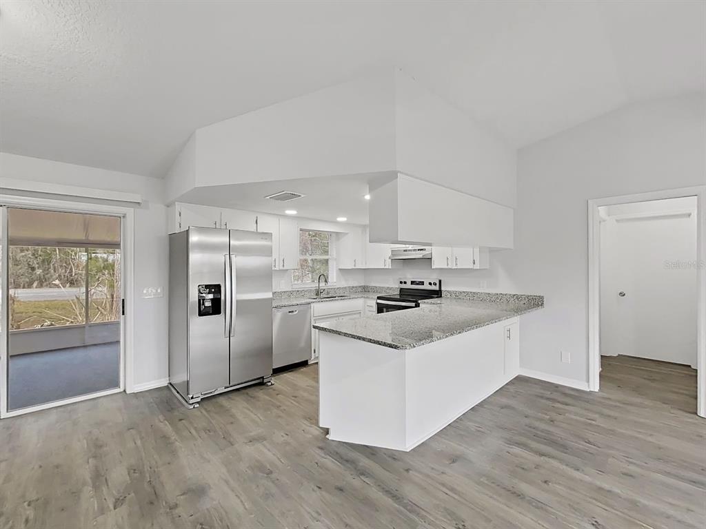 902 Great Pine Point Inverness, FL 34452 - Photo 13 of 39 a kitchen with stainless steel appliances a sink a stove a refrigerator and cabinets