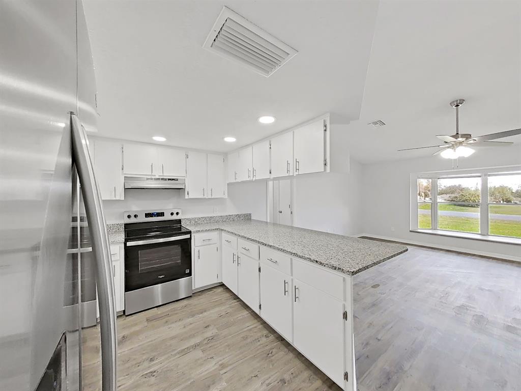 902 Great Pine Point Inverness, FL 34452 - Photo 15 of 39 a kitchen with stainless steel appliances granite countertop a stove a sink and a refrigerator