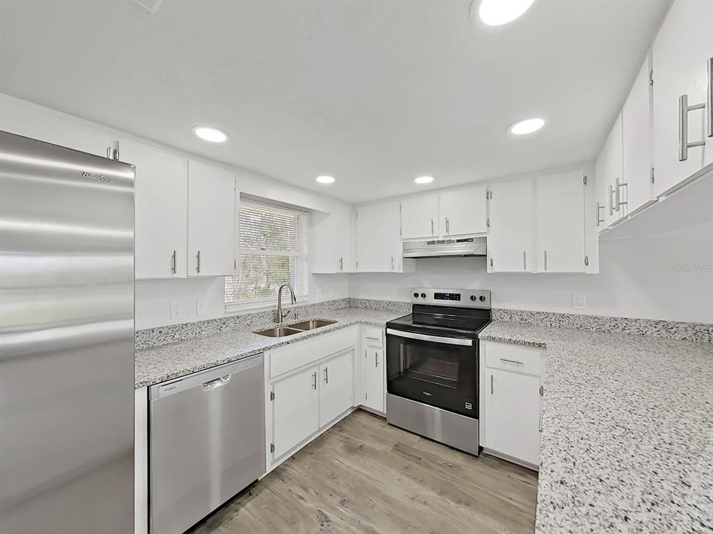 902 Great Pine Point Inverness, FL 34452 - Photo 16 of 39 a kitchen with stainless steel appliances granite countertop a sink and a stove