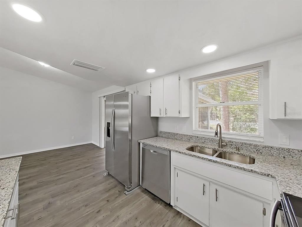 902 Great Pine Point Inverness, FL 34452 - Photo 18 of 39 a kitchen with a sink cabinets stainless steel appliances and a window