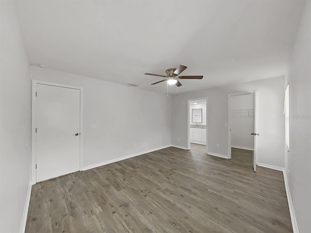 902 Great Pine Point Inverness, FL 34452 - Photo 20 of 39 a view of an empty room with window and wooden floor