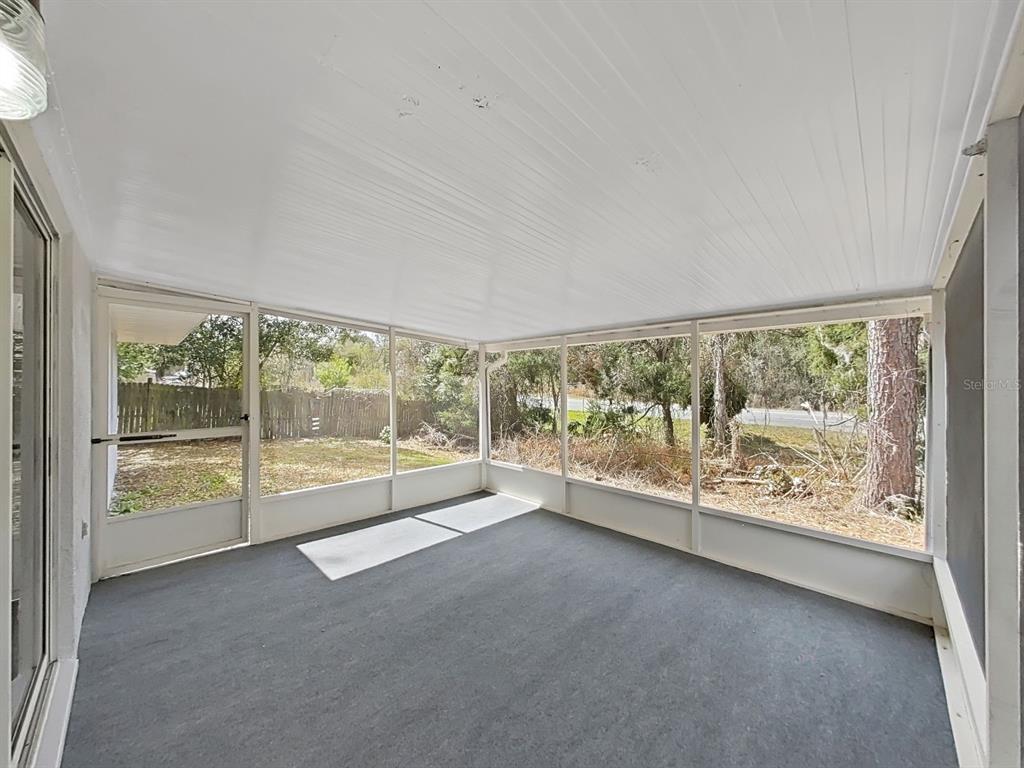 902 Great Pine Point Inverness, FL 34452 - Photo 33 of 39 an empty room with wooden floor and windows