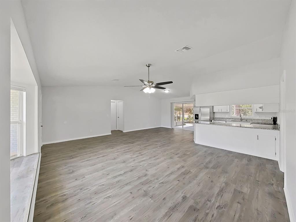 902 Great Pine Point Inverness, FL 34452 - Photo 7 of 39 a view of a kitchen with a sink dishwasher a kitchen cabinets and wooden floor
