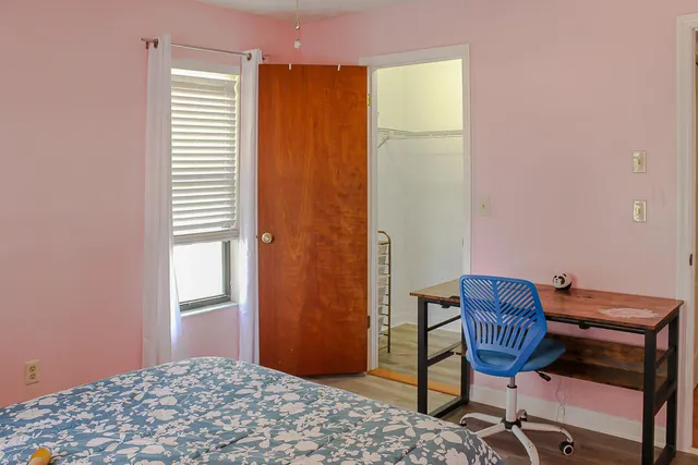 a view of a workspace room with furniture and wooden floor