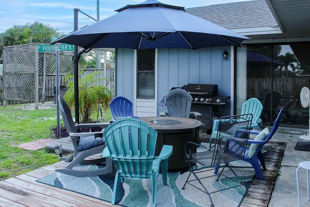 a backyard of a house with table and chairs