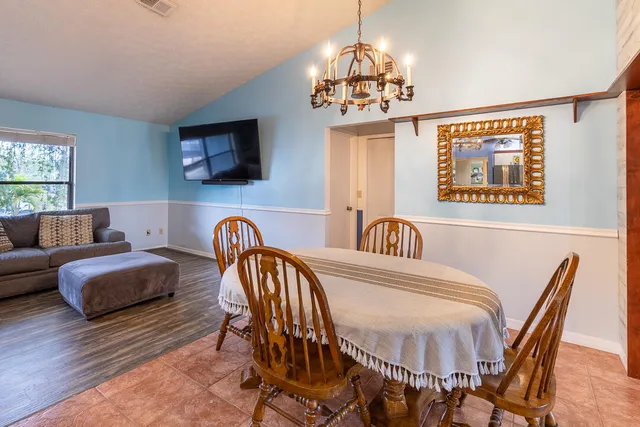 a view of a dining room with furniture wooden floor and chandelier