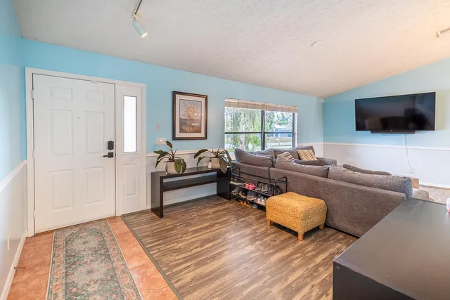 a living room with furniture and a flat screen tv