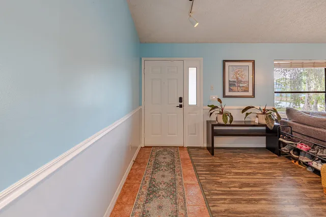 a spacious bedroom with a bed and a rug