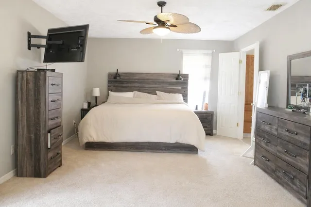 a bedroom with a bed and flat screen tv