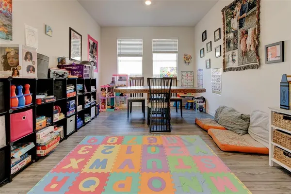 a living room with lots of furniture and a bookshelf