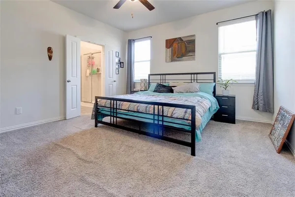 a spacious bedroom with a bed and a window