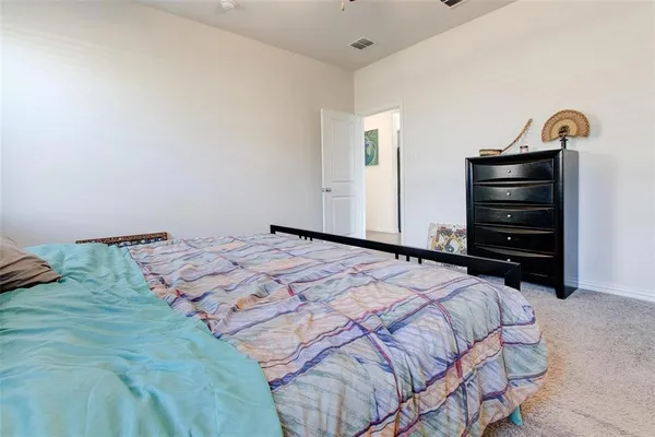 a bedroom with a bed and a dresser