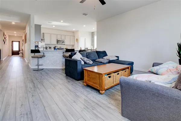 a living room with furniture and wooden floor