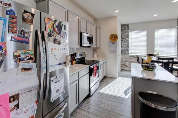 a kitchen with stainless steel appliances a sink and a refrigerator