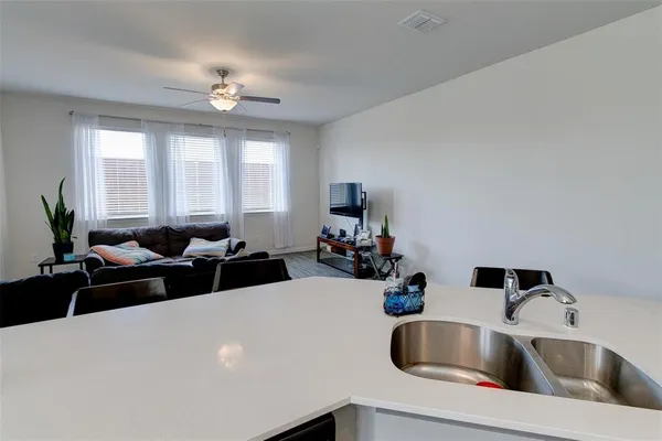 a living room with furniture and a chandelier