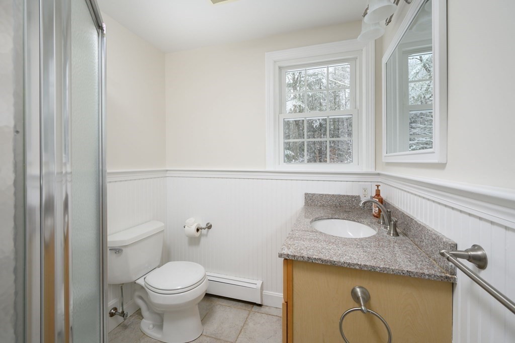571 Main Street Marshfield, MA 02050 - Photo 12 of 25 a bathroom with a granite countertop toilet sink and mirror