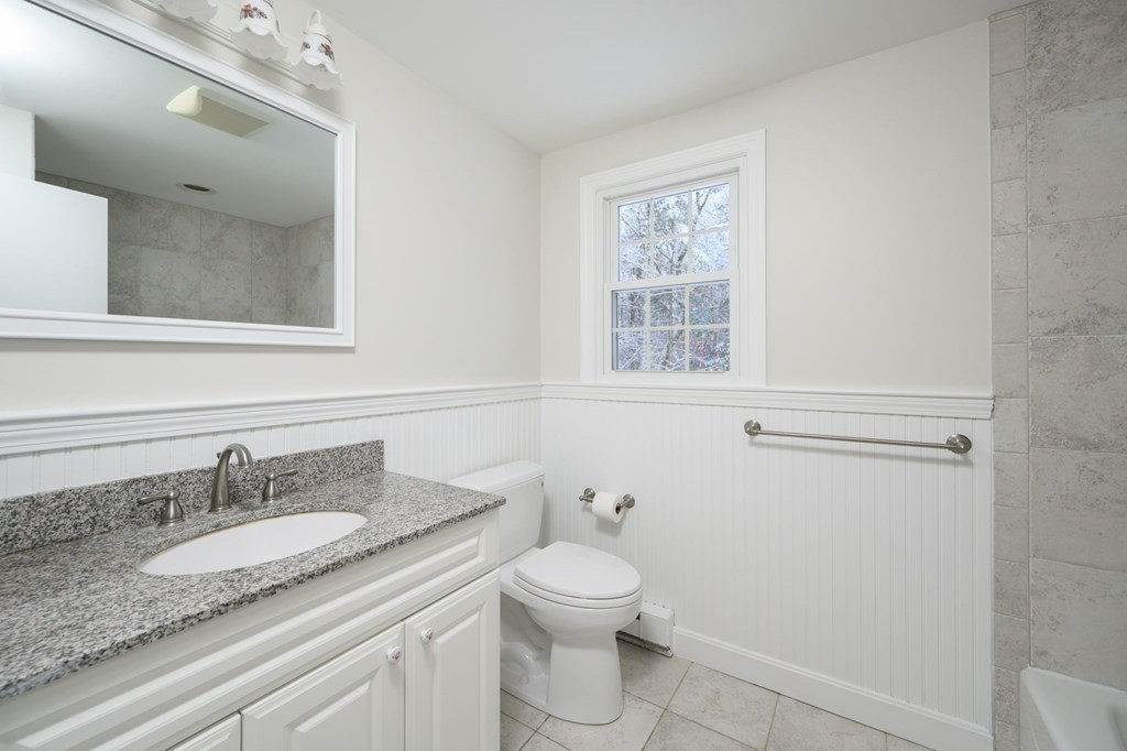 571 Main Street Marshfield, MA 02050 - Photo 17 of 25 a bathroom with a granite countertop sink toilet and mirror