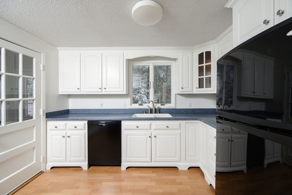 571 Main Street Marshfield, MA 02050 - Photo 6 of 25 a kitchen with granite countertop a sink dishwasher a stove and a refrigerator with wooden cabinets