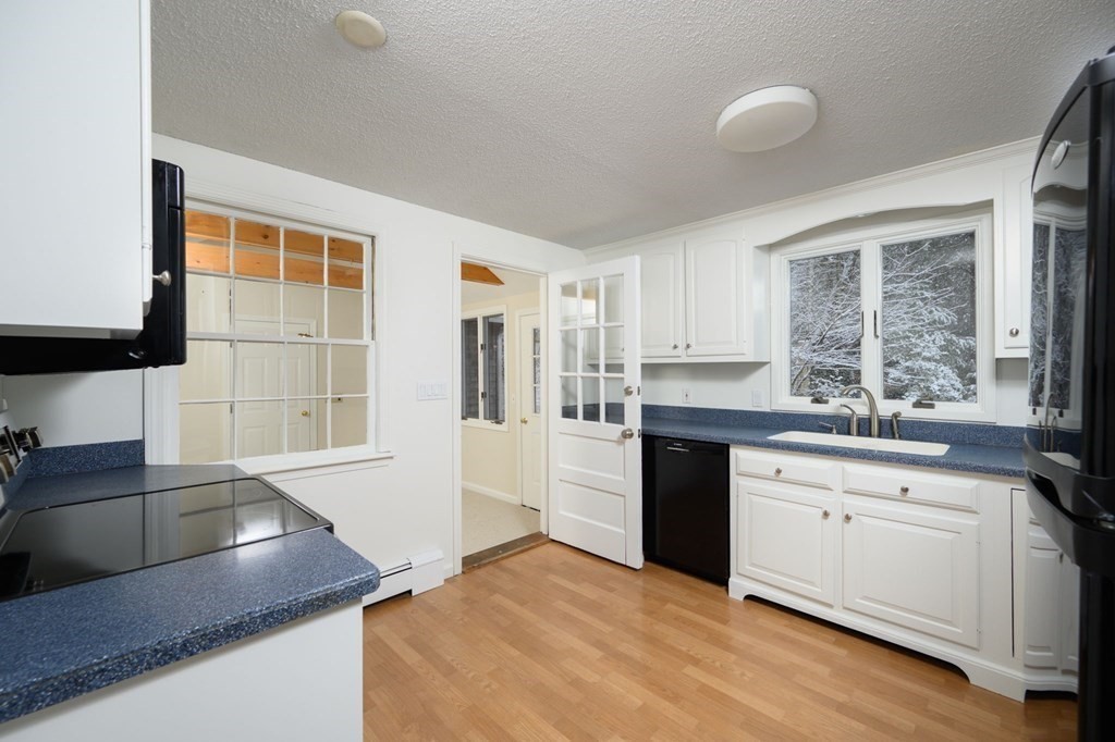 571 Main Street Marshfield, MA 02050 - Photo 7 of 25 a kitchen with stainless steel appliances granite countertop a sink and cabinets with wooden floor